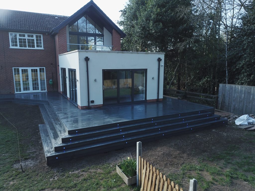 Large black anthracite decking around a white extension