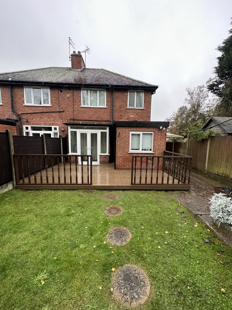 A brown decking outside of a house
