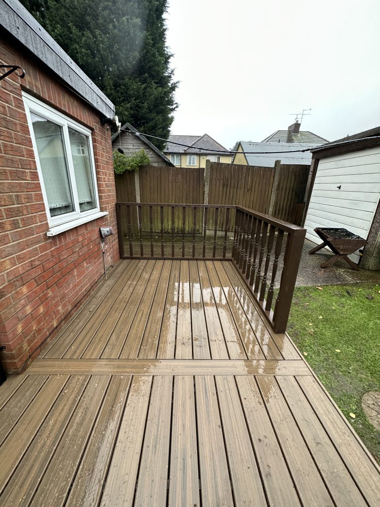 A brown decking outside next to a building